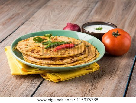 Traditional Indian bread - Aloo paratha or aalu parotha, potato stuffed bread. served with tomato ke