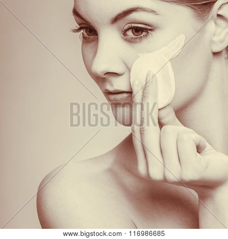 Woman Removing Makeup With Cream And Cotton Pad