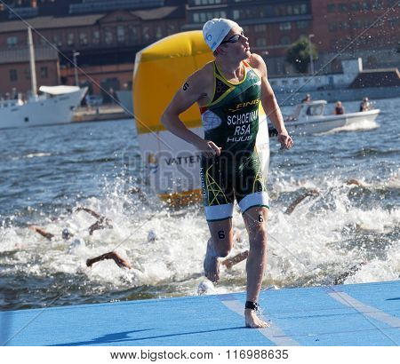 STOCKHOLM - AUG 22 2015: Swimmer Henri Schoeman (RSA) climbing up from the water in the Men's ITU World Triathlon series event August 22 2015 in Stockholm Sweden