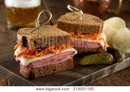 Smoked meat on rye sandwich with melted swiss cheese and coleslaw tossed in russian dressing.