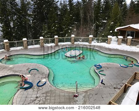 HALCYON HOT SPRINGS BRITISH COLUMBIA/ CANADA - DECEMBER 26 2016: People relaxing in 37 degrees Celsius mineral pool.