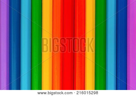 Background of colorful wooden pencils. Rainbow colors. Vertical.