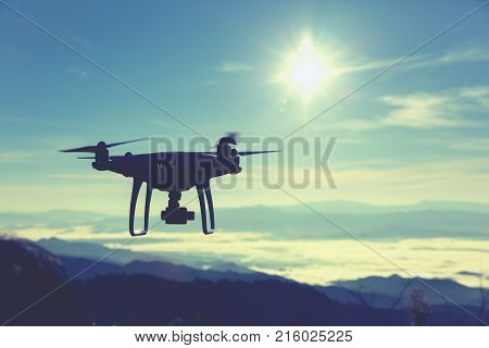 drone pilotage at sunrise over the fog.