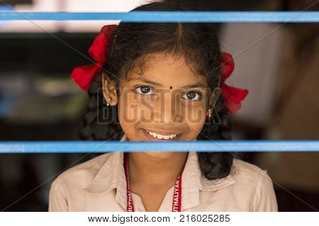 PONDICHERY PUDUCHERY INDIA - SEPTEMBER 04 2017. Unidentified child at schhol behind the window