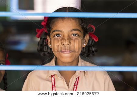 PONDICHERY PUDUCHERY INDIA - SEPTEMBER 04 2017. Unidentified child at schhol behind the window