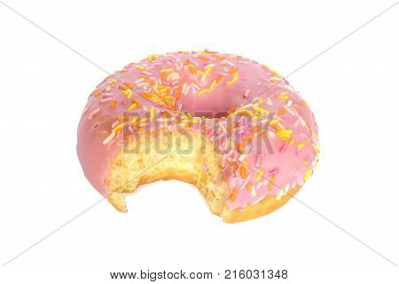one bite missing of donut with pink frosting and colorful sugar sprinkles isolated on white background
