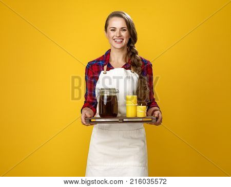 Woman Cook Showing Jar With Honey And Wax Candles On A Trey