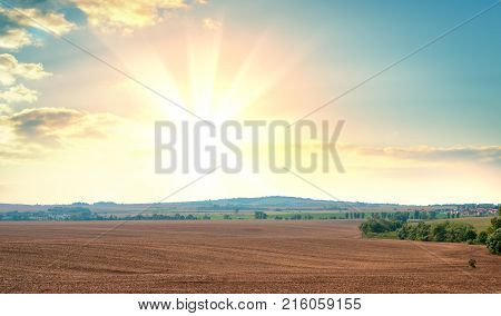 Sunrise over fields and distant woods. Beautiful background