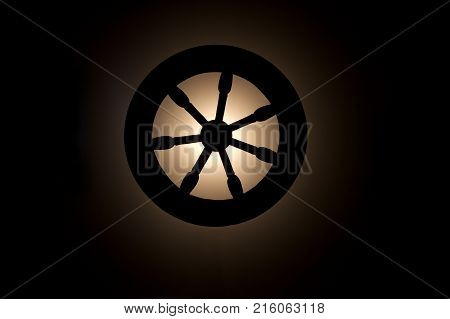 Vintage spinning wheel on dark background.Life circle concept.