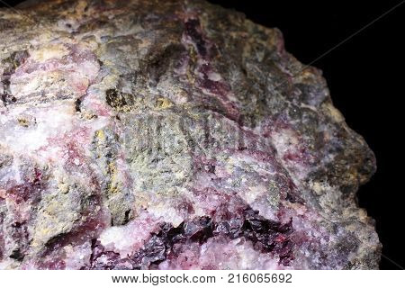 Cinnabarite mineral abstract look on black background, natural phenomenon, closeup photograph.