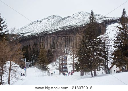 HREBIENOK, SLOVAKIA - JANUARY 07, 2015: View of the center of Hrebienok village with High Tatra Mountains on the background. Hrebienok is a small ski and hiking resort in the Slovakia.