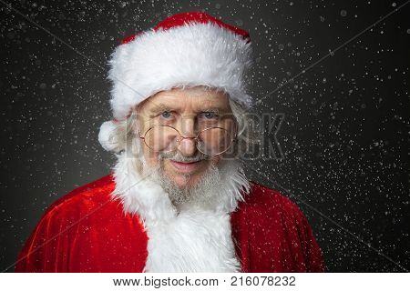 Christmas Santa Claus on dark background with snow