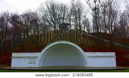 White concert shell among autumn trees. Big Cross and cableway to Kamienna Gora, Gdynia, Poland
