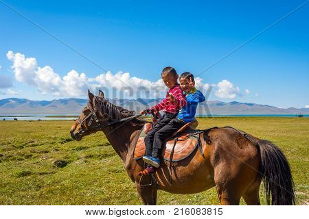 Two Kids Riding A Horse