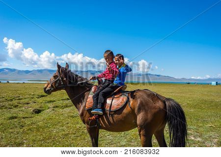 Two Kids Riding A Horse