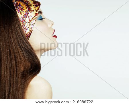 young pretty modern girl with bright shawl on head emotional posing isolated on white background, lifestyle people concept copyspace