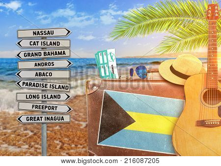 Concept of summer traveling with old suitcase and Bahamas with burning sun