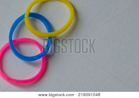 yellow blue pink plastic rubber on white background copy space isolated