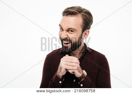 Portrait of a sneaky bearded man planning something isolated over white background