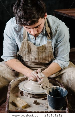 Handsome Young Mexican Potter Does Sketches Of Ceramics On The Paper. Concept Of Small Business, Han