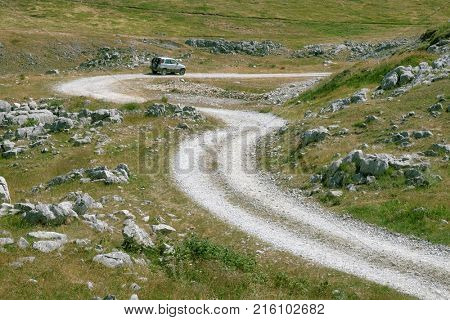 LUKAVICA, MONTENEGRO - JULY 18, 2017: off road car on a curvy and rough road of Montenegro Mountain 