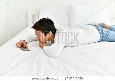 Men are playing mobile in the bedroom.
