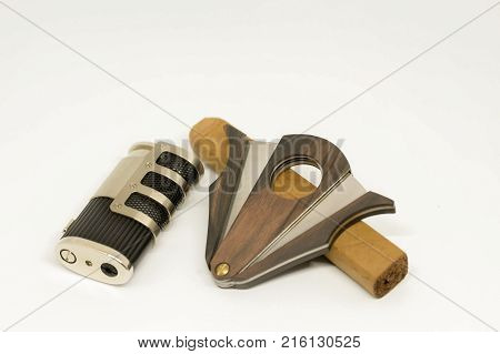 Metal Lighter and cigar cuter on white backdrop