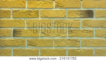 Decorative brick wall from concrete facing tiles as background or texture.