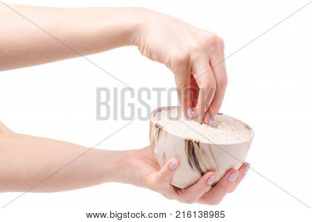 Rice croquet in a pial plate female hands on a white background isolation