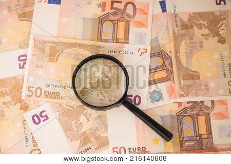 Background with euro money. Magnifier focused on keys. Euro banknotes. 50 euro.