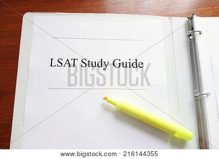 LSAT Study Guide on a desk with highlighter -- Law school concept