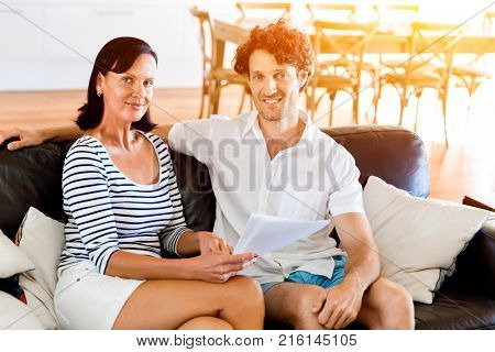 Couple with papers in their living room