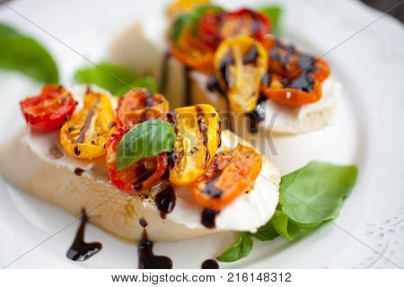 Bruschetta with cream cheese, half dried tomatoes and basil