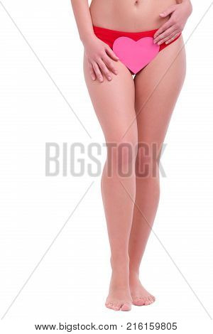 Body of a girl, below the belt, in red shorts with a pink heart, against the background of the inguinal zone, the concept of depilation, hair removal, isolated on a white background