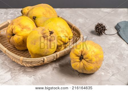 Close up of ripe quince fruits on kitchen countertop.