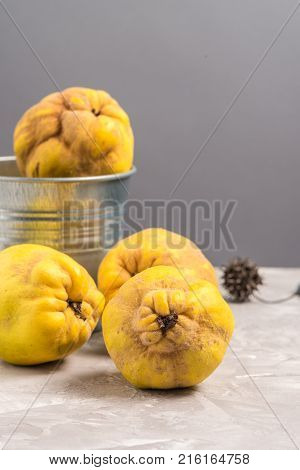 Close up of ripe quince fruits on kitchen counter top.