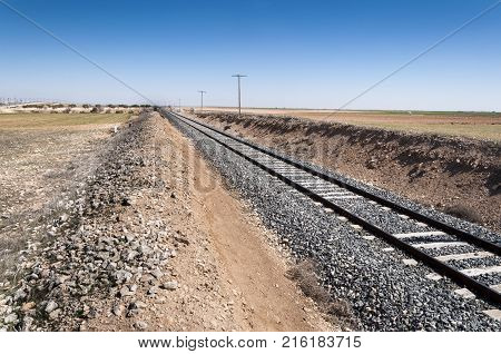 Conventional rail in an agricultural landscape in Toledo Province, Spain.