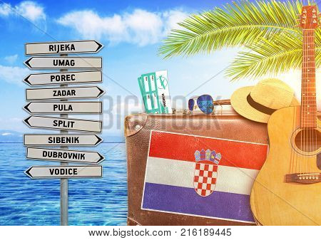 Concept of summer traveling with old suitcase and Croatia with burning sun