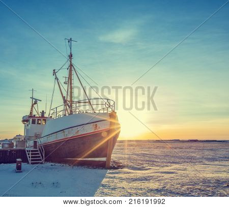 Old fisherman iron boat in Iceland, grunge colored design