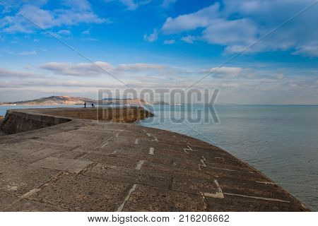 The famous cobb in Lyme Regis England. The Cobb an old stone pier forming an extensive harbour and believed to date from the time of Edward I.