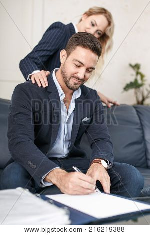 Young crafty blonde woman seducing rich businessman to sign documents swindler managers