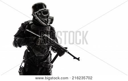 Futuristic nazi soldier sentinel gas mask and steel helmet with schmeisser handgun isolated on white studio shot standing to attention profile