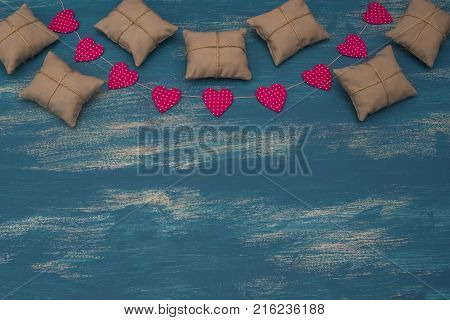 Valentine's day background with Decorative composition garland on painted wood background. Top view Flat lay