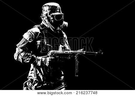 Futuristic nazi soldier gas mask and steel helmet with schmeisser handgun black background studio shot