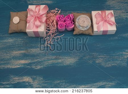 Decorative composition holiday boxes with gifts. Womens costume jewelry flowers. Flat lay