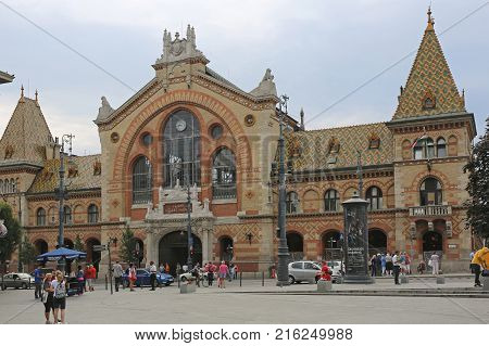 BUDAPEST HUNGARY - JULY 13 2015: Central Market Hall at Fovam Square With People and Traffic in Budapest Hungary.