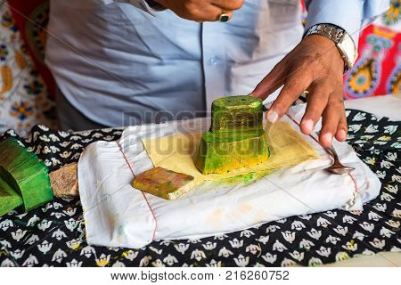 Close up stamp applying dye on cloth