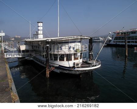 Ferry moored at the pier of the port of Arona on Lake Maggiore