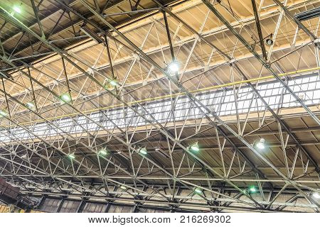 Metal trusses covering an industrial long-span building with an antiaircraft lantern of natural light