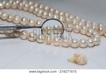 bad rotten tooth pulled out and is opposite the dental mirror and dazzling pearls